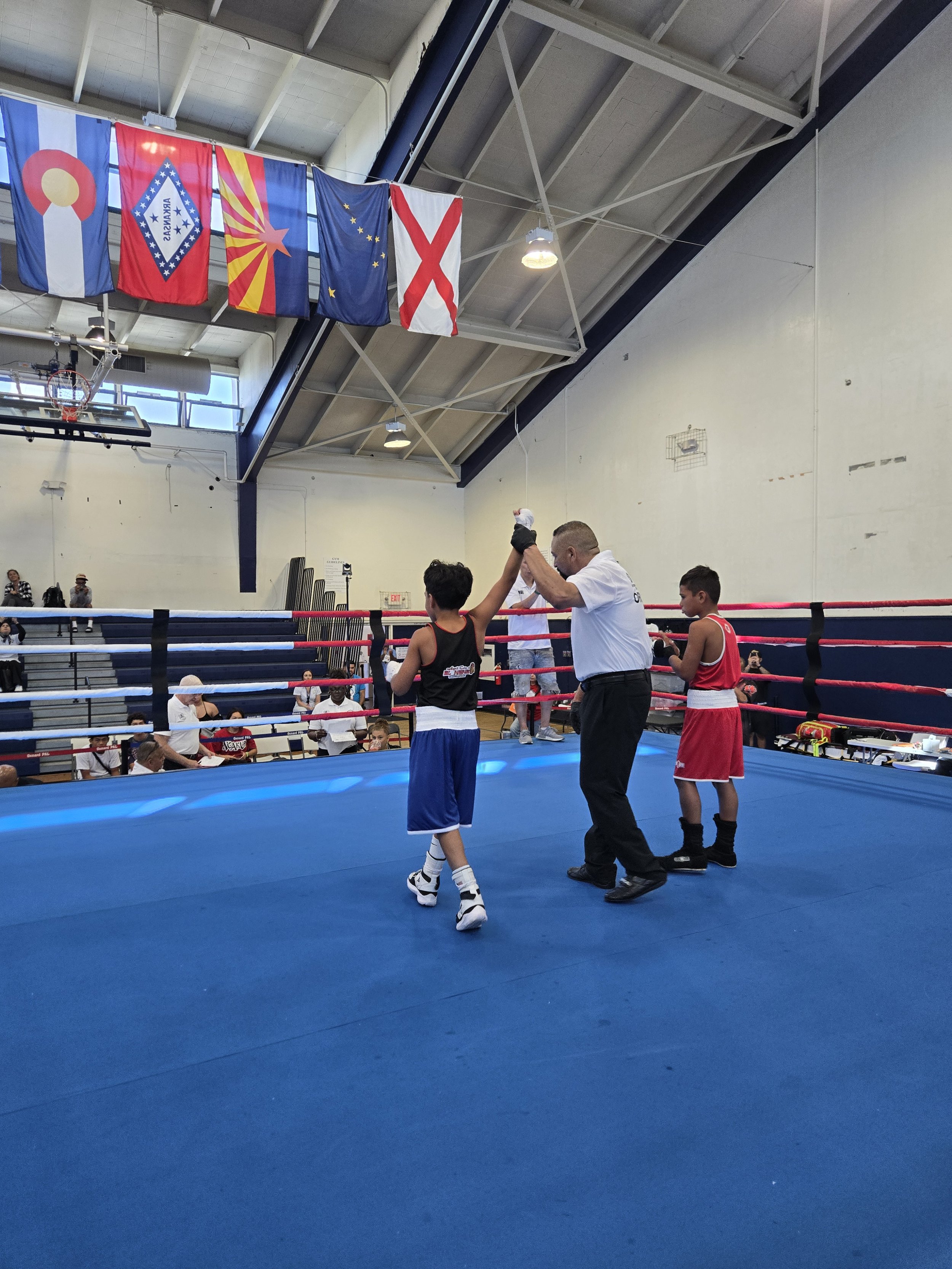 Youth boxer getting hand raised after a match