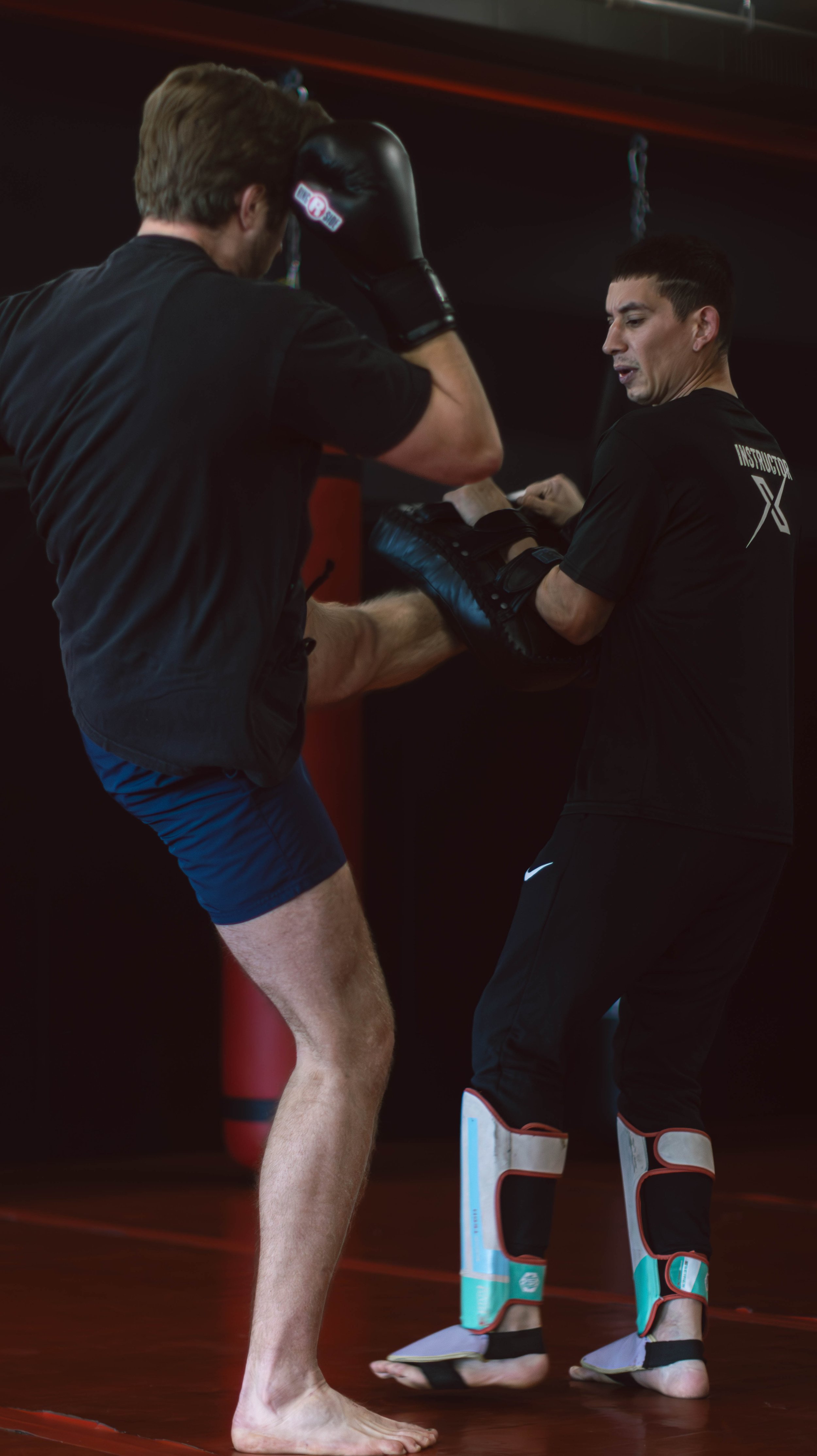 Muay Thai training with shin guards and pad work